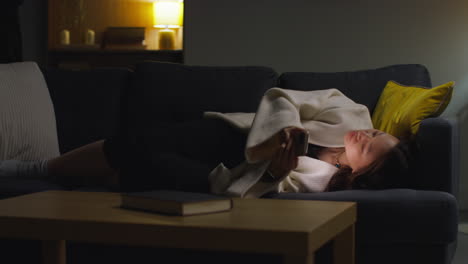 Woman-Spending-Evening-At-Home-Lying-On-Sofa-With-Mobile-Phone-Scrolling-Through-Internet-Or-Social-Media-17